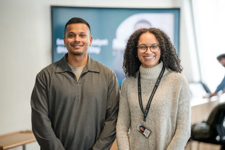 Two participants stand together for a portrait.