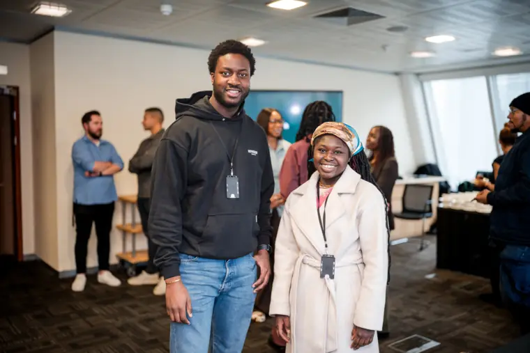 Two attendees stand together for a portrait.