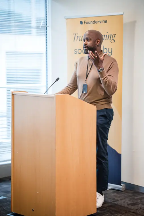A founder answers questions from the front of the room.