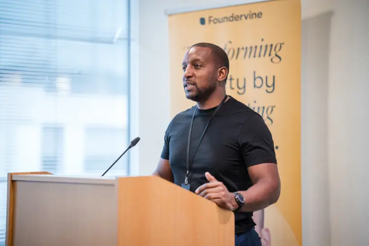 A founder speaks at the lectern during the showcase.