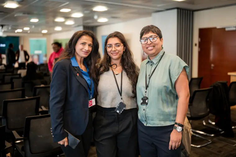 Three guests pose together after the talks.