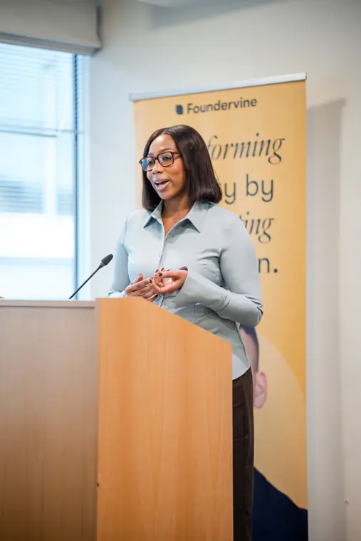 A speaker addresses the audience during the showcase.