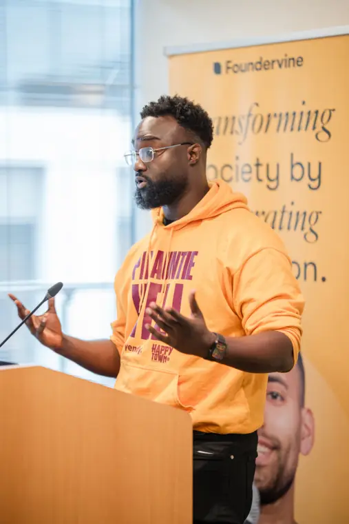A founder addresses the room from the Foundervine lectern.
