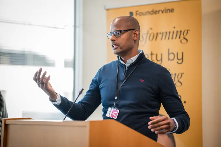 A speaker gestures during his presentation.