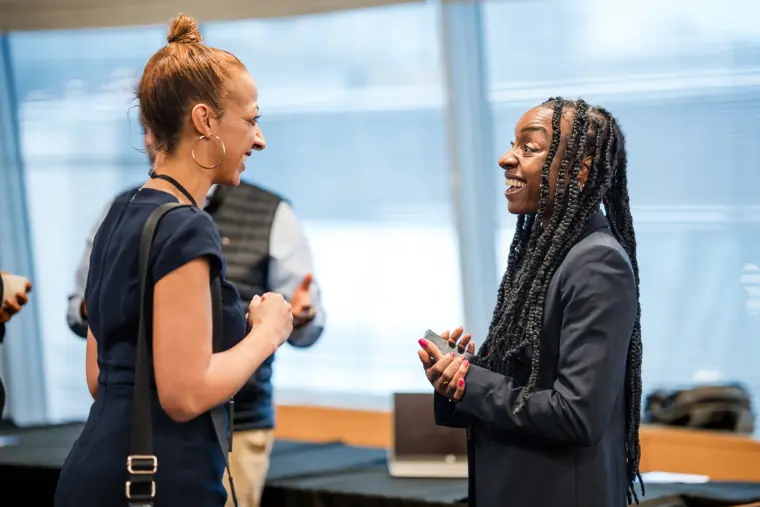 Two participants exchange ideas during a break.