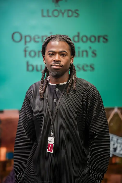 A founder poses in front of the Lloyds business backdrop.