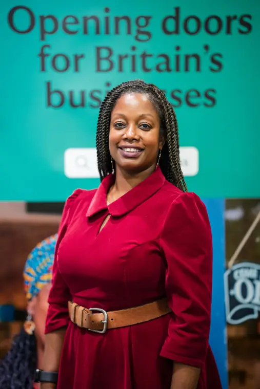 An attendee stands for a portrait by the Lloyds backdrop.