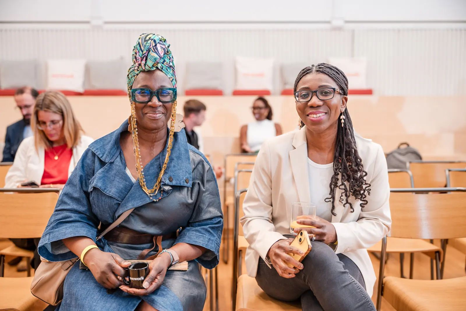 Two guests sit together at the community gathering.