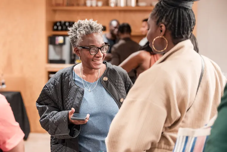 A guest speaks with another attendee during the gathering.