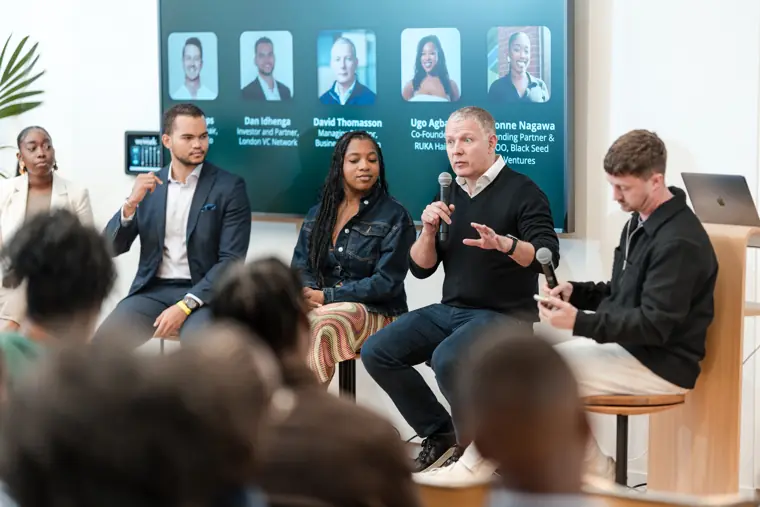 Panellists discuss business growth on stage.