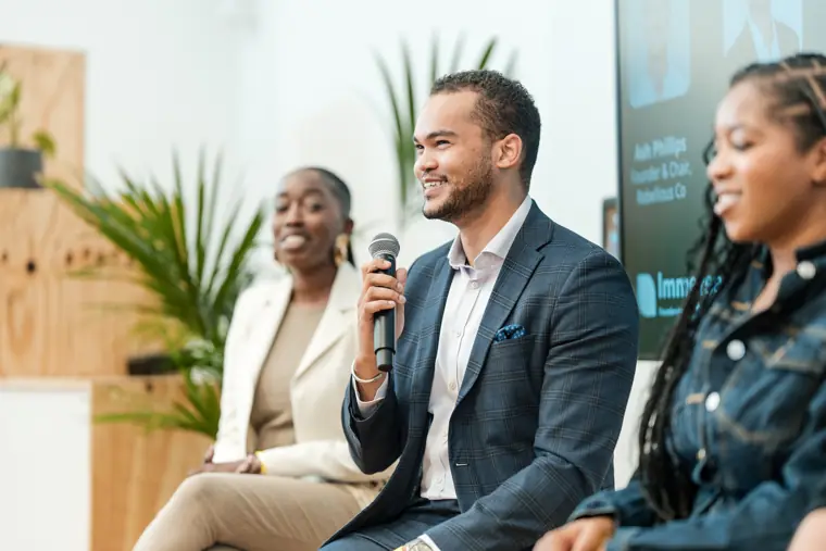 A speaker smiles during the panel conversation.
