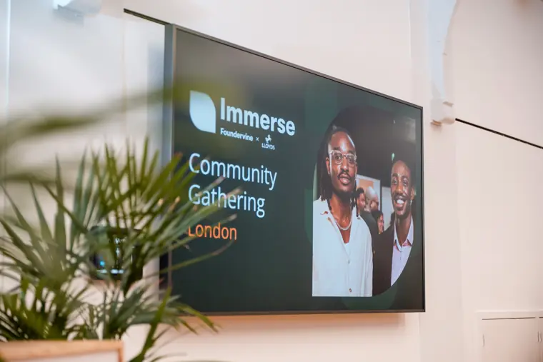 The London community gathering displayed on screen.