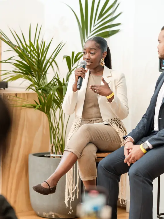 A speaker addresses the panel from her seat.