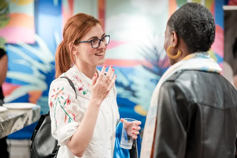 Guests exchange ideas over a drink.