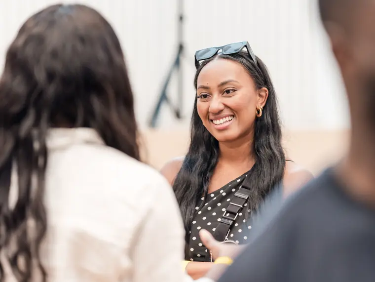 Two attendees chat after a presentation.