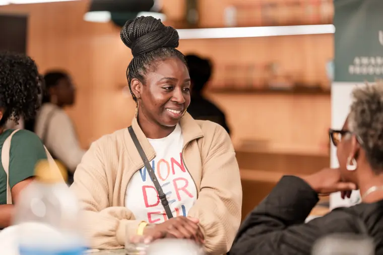 An attendee smiles during a discussion.