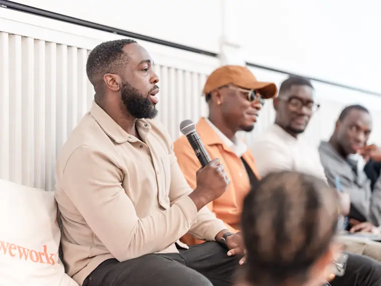 A guest asks a question from the audience.