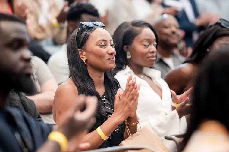 Guests applaud from their seats.