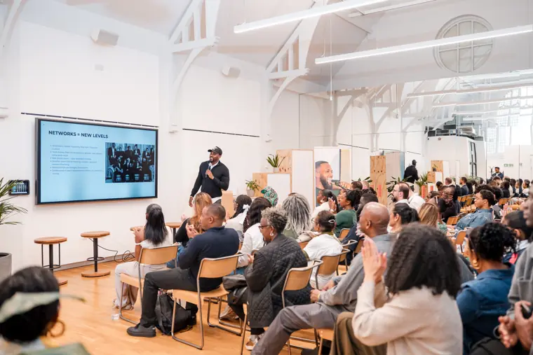 The audience listens to a presentation.