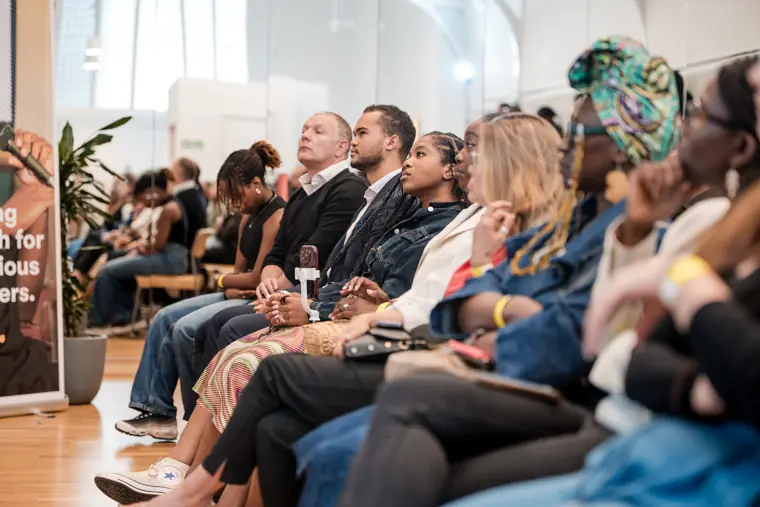 The audience fills the room for the discussion.
