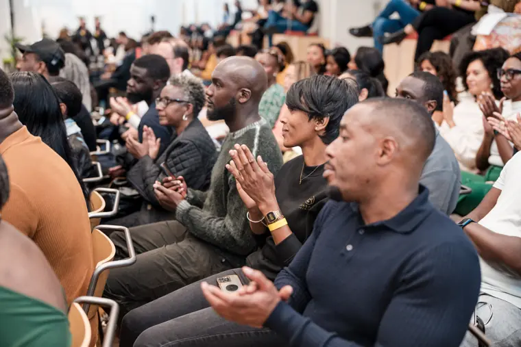 Guests applaud the panellists.