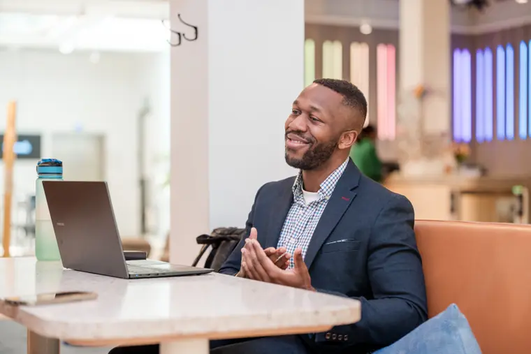 A guest smiles during a mentoring conversation.
