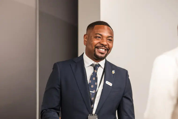 A guest smiles during the welcome reception.
