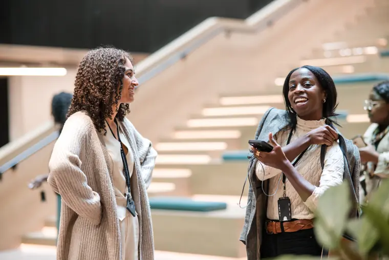 Attendees meet on the venue staircase.