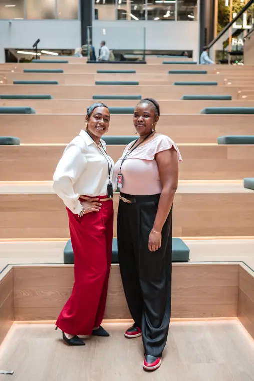 Two attendees pose on the venue staircase.