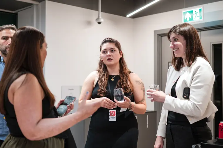 Three attendees talk during the reception.