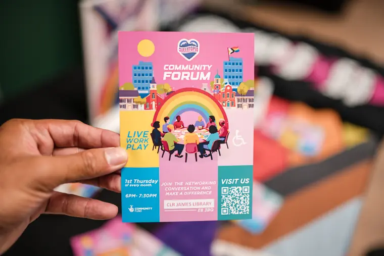 A guest holds an event programme card.