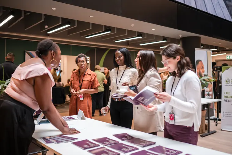 Guests discuss the founder information on display.