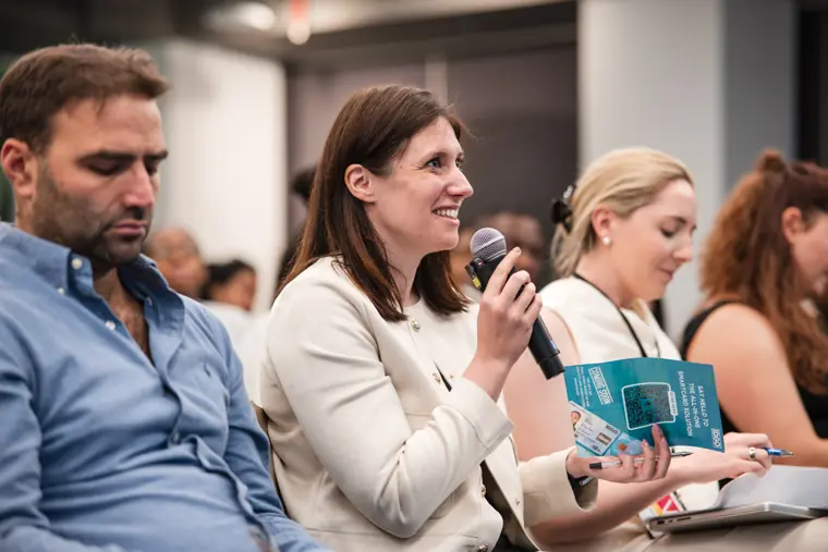 An audience member asks a question into the microphone.