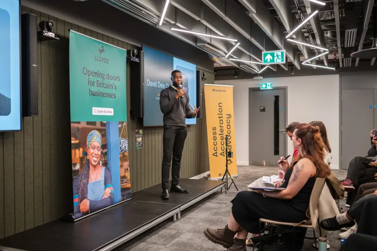 A wide view of a founder presenting.