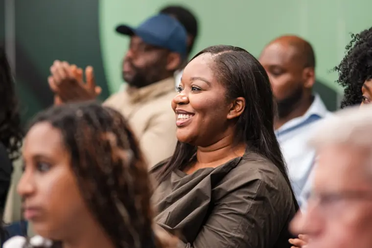 A guest smiles as the pitches continue.