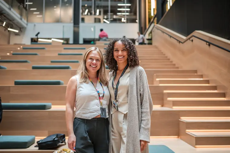 Two attendees pose on the staircase.