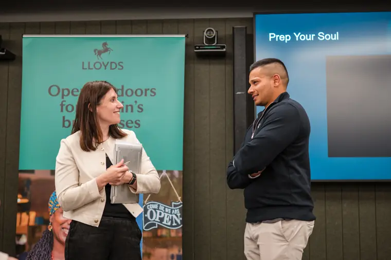 A speaker and attendee exchange ideas.