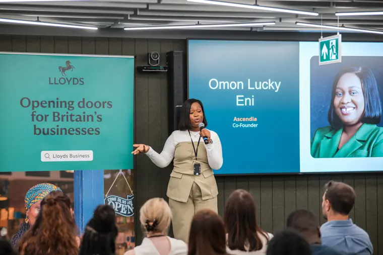 The audience watches a founder on stage.