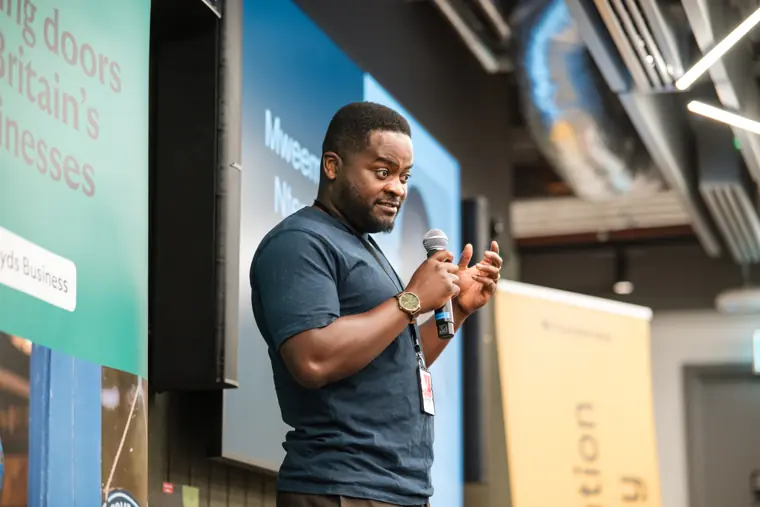 A founder presents his business to the room.