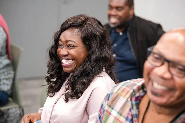 A guest smiles during the presentations.