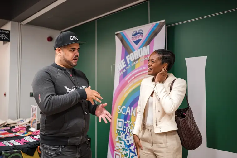 Two attendees discuss the founder programme.