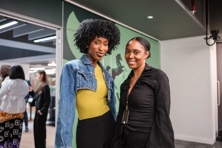 Two guests pause for a portrait in the networking space.