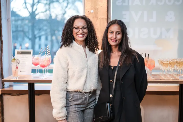 Two guests smile for a portrait at the mixer.