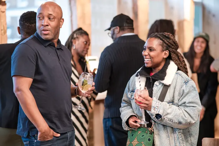 Guests share a conversation over drinks.