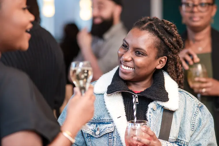 An attendee smiles during a networking conversation.