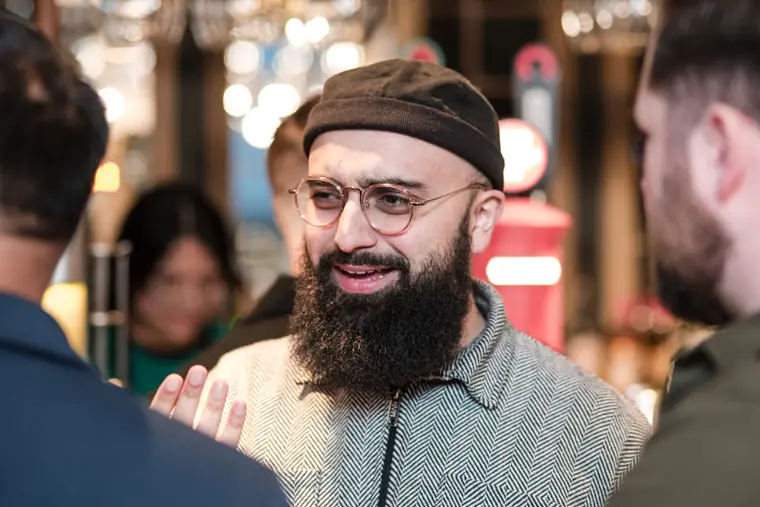 A founder joins a discussion at the bar.