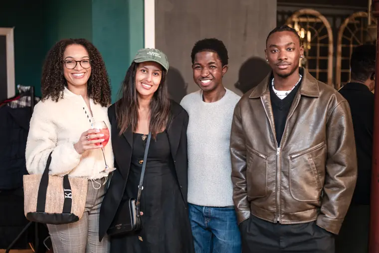 Four attendees pose for a group portrait.