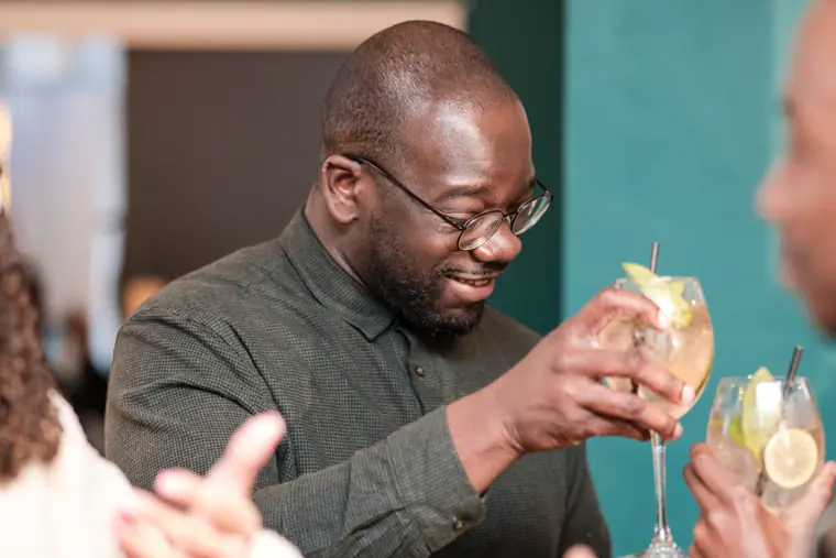 A guest raises a glass during networking.