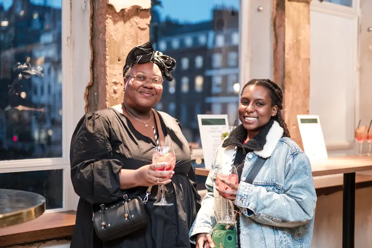 Two guests smile for a photograph.