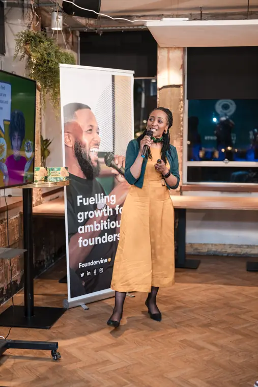A founder presents her venture to the room.
